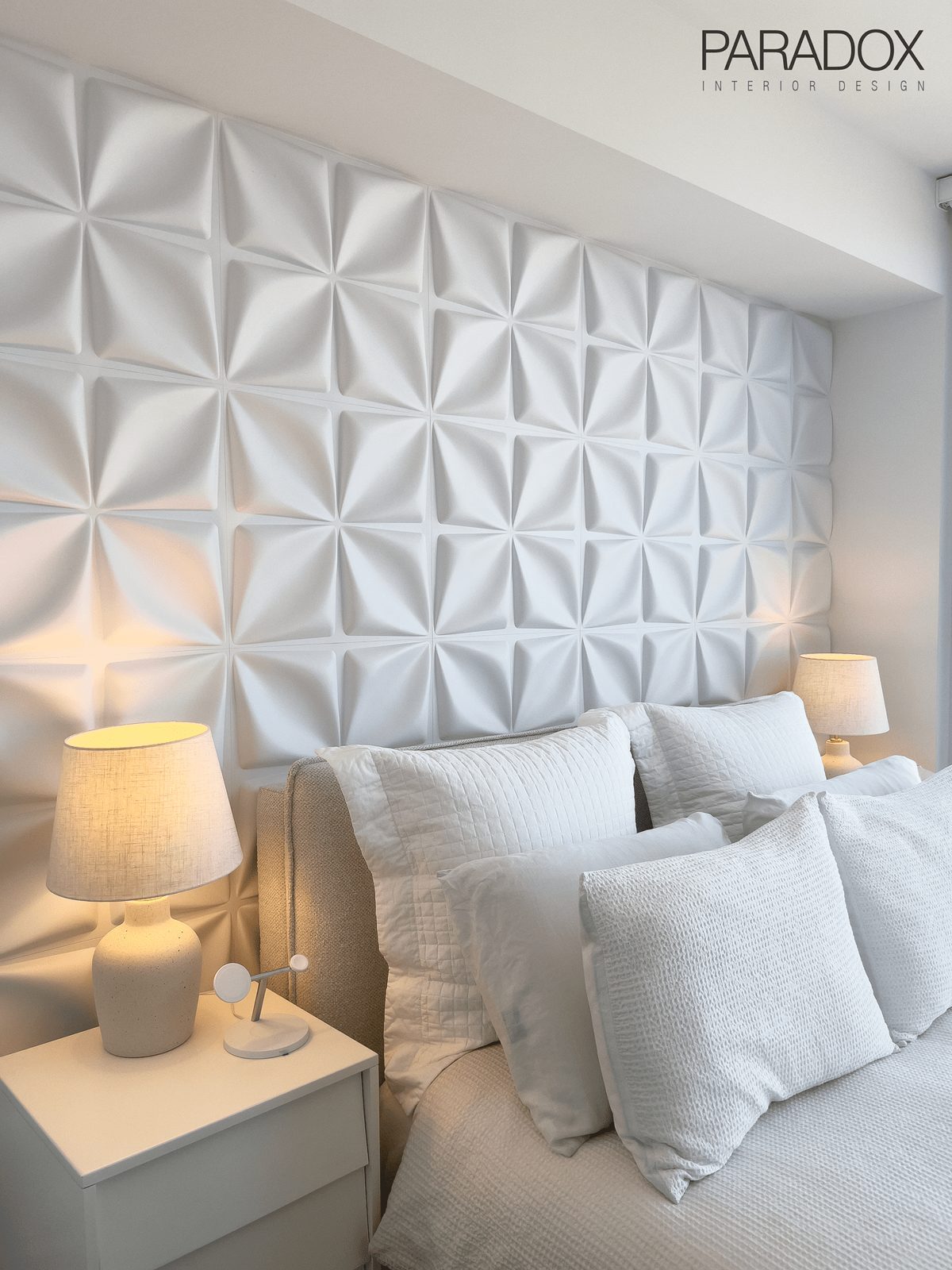 Monochromatic bedroom in a downtown Toronto condo with a custom upholstered headboard and layered textures, view 2