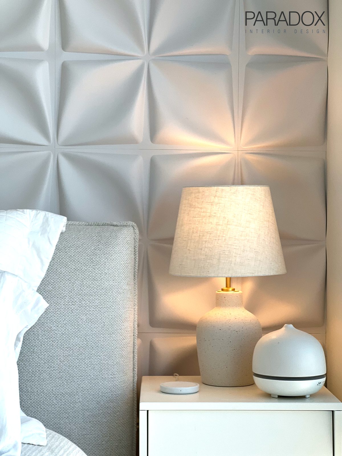Monochromatic bedroom in a downtown Toronto condo with a custom upholstered headboard and layered textures, view 3
