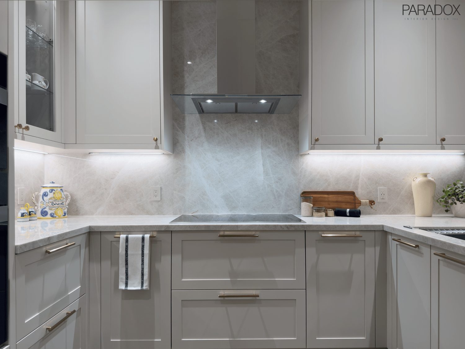 Renovated Bridle Path kitchen in Toronto with white custom cabinetry and Taj Mahal quartzite counters and backsplash, view 3