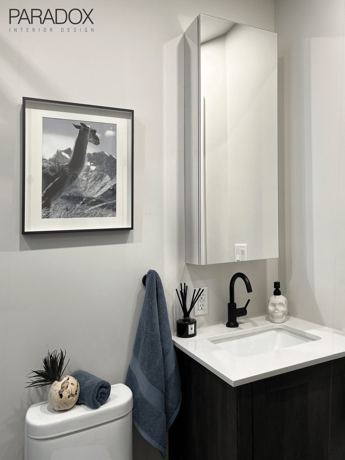 Bright renovated ensuite bathroom in Toronto with light porcelain tile, new vanity and mirrored medicine cabinet, view 2