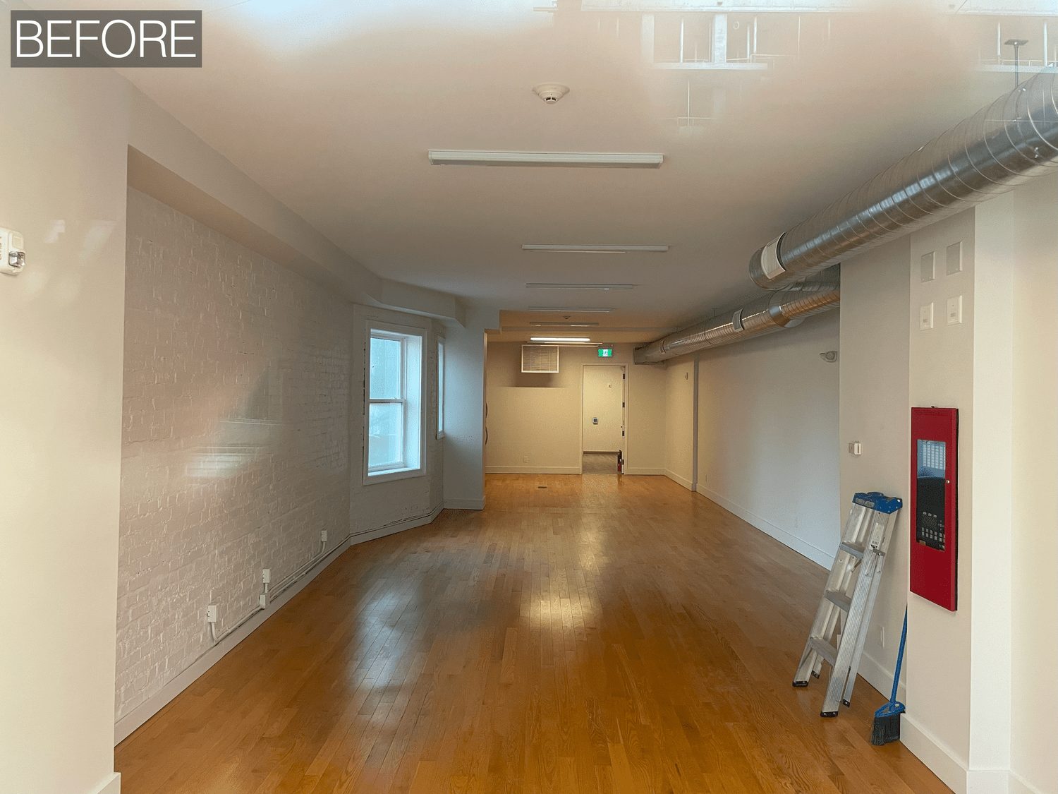 Tattoo studio interior in Toronto designed with warm, residential-style lounge areas and workstations, view 4